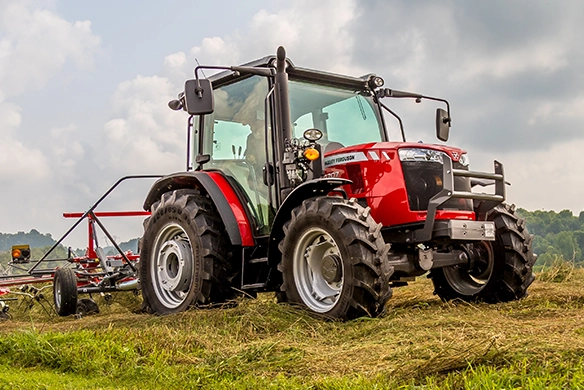 Massey Ferguson 4700 Series tractor three-quarter view with rotary rake in a grassy field